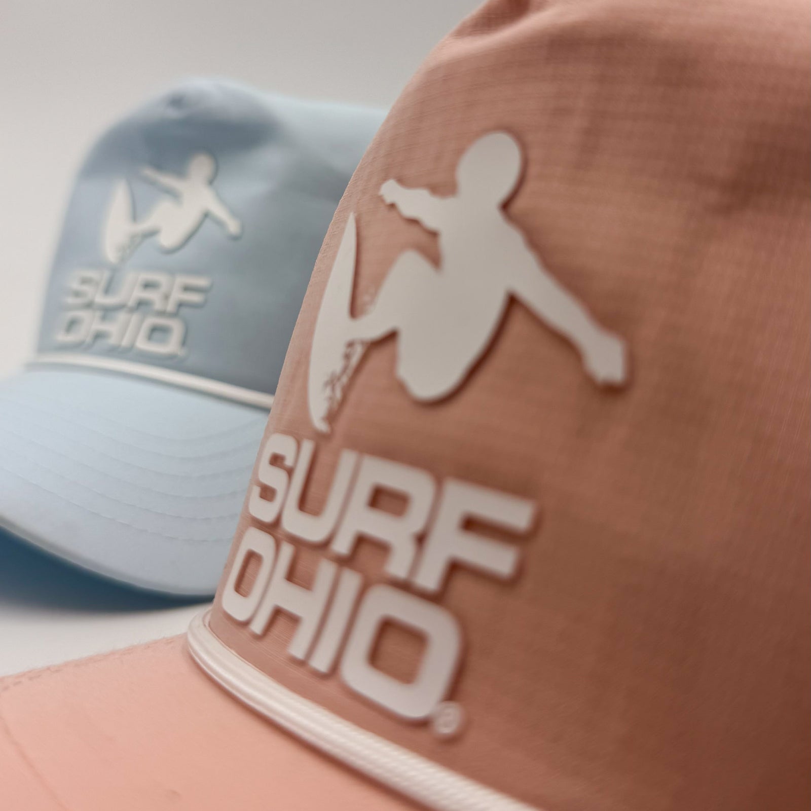 Peach and Chambray Surf Ohio rope hats, raised silicone logo detail